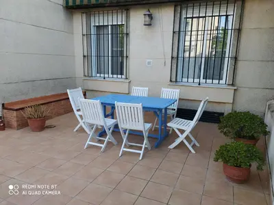 a blue table and chairs on a patio at Casa playa Bajo de Guía-Centro in Sanlúcar de Barrameda