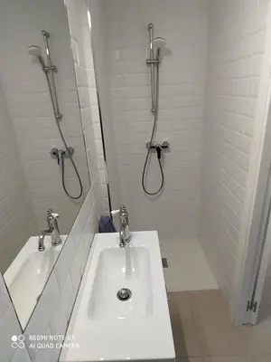 a bathroom with a sink and two shower heads at Casa playa Bajo de Guía-Centro in Sanlúcar de Barrameda
