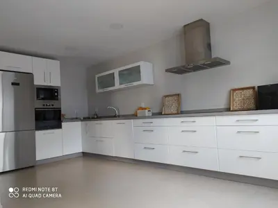 a white kitchen with white cabinets and appliances at Casa playa Bajo de Guía-Centro in Sanlúcar de Barrameda
