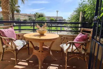 a table and chairs on a balcony with a table at La Casita de Guía by Sanlúcar Housing in Sanlúcar de Barrameda