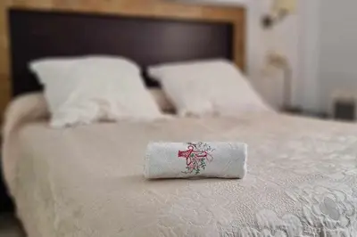a towel sitting on top of a bed at La Casita de Guía by Sanlúcar Housing in Sanlúcar de Barrameda