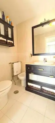 a bathroom with a toilet and a sink and a mirror at La Casita de Guía by Sanlúcar Housing in Sanlúcar de Barrameda