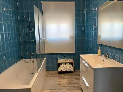 a bathroom with a tub and a sink and a shower at las camelias in El Puerto de Santa María