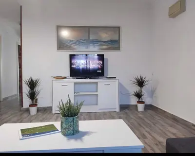 a living room with a tv on a white cabinet at las camelias in El Puerto de Santa María
