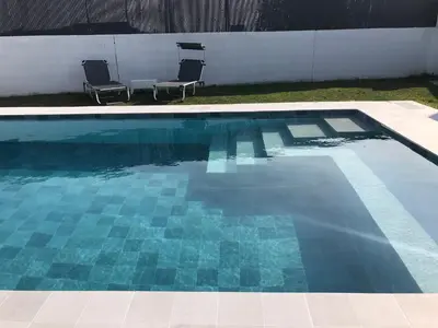 two chairs sitting next to a swimming pool at las camelias in El Puerto de Santa María