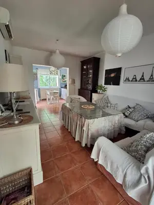 a living room with a table and a couch at Casa en Loma Sancti Petri a 900 m de la playa de La Barrosa in Chiclana de la Frontera