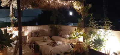 a patio with a couch and a table and some plants at Casa en Loma Sancti Petri a 900 m de la playa de La Barrosa in Chiclana de la Frontera