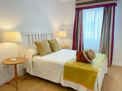 a bedroom with a bed with a hat on it at Eva Recommends Francos in Jerez de la Frontera