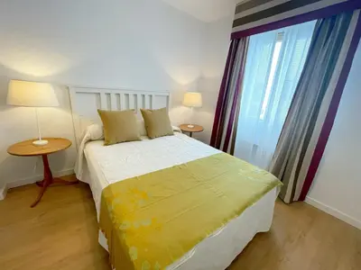 a bedroom with a bed and two lamps and a window at Eva Recommends Francos in Jerez de la Frontera