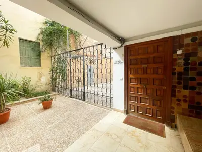 an entrance to a house with a wooden door at Eva Recommends Francos in Jerez de la Frontera