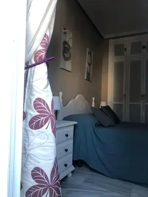 a bedroom with two twin beds and a dresser at Calma La Barrosa Apartamento in Chiclana de la Frontera