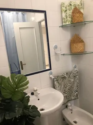a bathroom with a sink and a mirror at Calma La Barrosa Apartamento in Chiclana de la Frontera