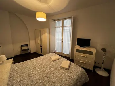 a bedroom with a bed and a tv on a dresser at Casa Ayuntamiento Ascensor Grupo AC Gestion in Cádiz