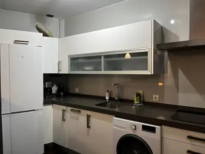 a kitchen with white cabinets and a washing machine at Casa Ayuntamiento Ascensor Grupo AC Gestion in Cádiz