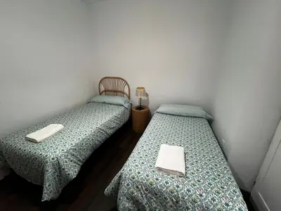 two beds sitting next to each other in a room at Casa Ayuntamiento Ascensor Grupo AC Gestion in Cádiz