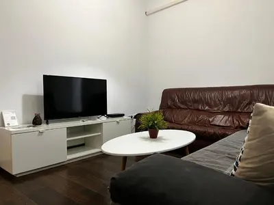 a living room with a couch and a flat screen tv at Casa Ayuntamiento Ascensor Grupo AC Gestion in Cádiz