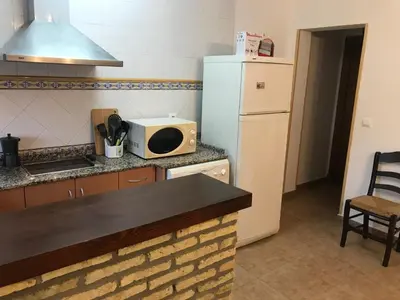 a kitchen with a white refrigerator and a microwave at Conil Colorado 1 rústico y económico in Conil de la Frontera