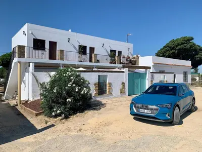 a blue car parked in front of a house at Conil, Colorado 2 rustico y económico in Conil de la Frontera