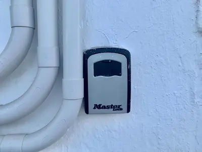 a cell phone is attached to a wall with pipes at Conil, Colorado 2 rustico y económico in Conil de la Frontera