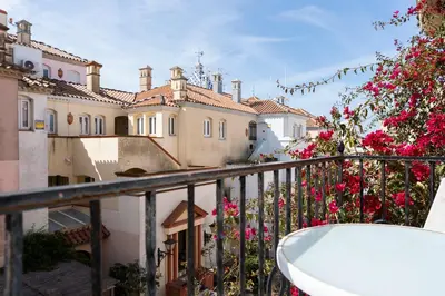 a balcony of a building with pink flowers at Apartamento Puerto Sherry in El Puerto de Santa María