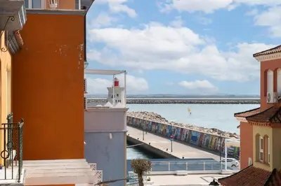a view of a body of water with a lighthouse at Apartamento Puerto Sherry in El Puerto de Santa María