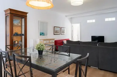 a living room with a glass table and a couch at Apartamento Puerto Sherry in El Puerto de Santa María