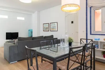a living room with a glass table and a couch at Apartamento Puerto Sherry in El Puerto de Santa María