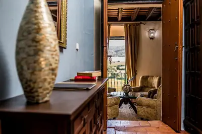 a living room with a table with a vase on a counter at Hacienda El Santiscal in Arcos de la Frontera