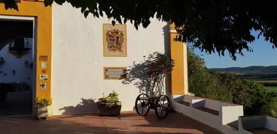 a building with a bike parked in front of it at Hacienda El Santiscal in Arcos de la Frontera