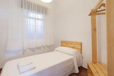 a bedroom with a white bed and a window at Precioso y luminoso apartamento Calle Corredera. Casco Histórico in Arcos de la Frontera