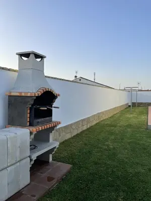 a pizza oven sitting on the side of a building at CASA SUROESTE in Conil de la Frontera