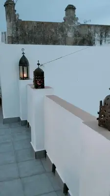 a white wall with two lights on top of it at Ático Plaza 9 by casitasconencantoes in Medina Sidonia