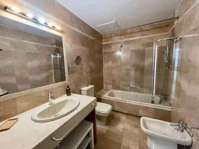 a bathroom with a sink and a toilet and a tub at Las Marinas de la Bahia in Cádiz