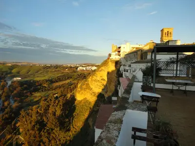 a view from the top of a building with a cliff at La Casa Grande in Arcos de la Frontera