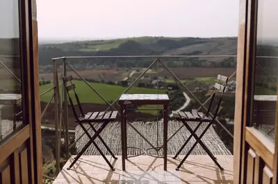 two chairs sitting on top of a balcony at La Casa Grande in Arcos de la Frontera