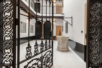 an open iron gate in a hallway with a staircase at Allo Apartments San Roque Bajo A in Cádiz