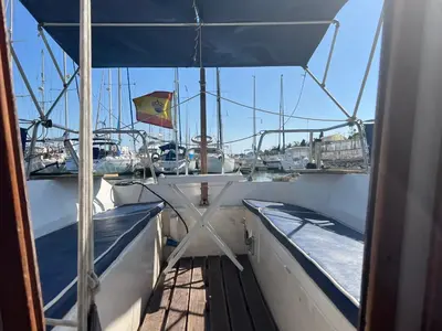 a boat with a flag on the side of it at Velero en el corazón de El Puerto de Santa María in El Puerto de Santa María