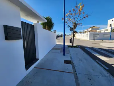 a building with a black door on the side of a street at Minichalet Jacaranda in Chiclana de la Frontera