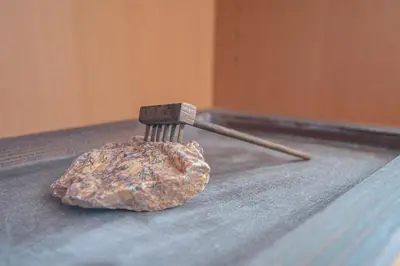 a rock on a table with a wooden stick at Apartamento Tribalia Cadiz in Cádiz
