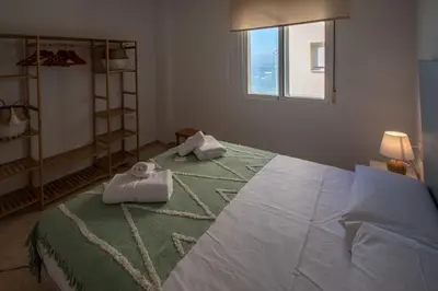 a bedroom with a large bed with towels on it at Apartamento Tribalia Cadiz in Cádiz