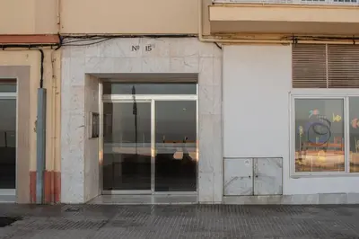 a building with a glass door on the side of it at Apartamento Tribalia Cadiz in Cádiz