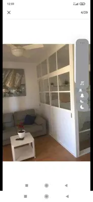 a living room with a couch and a coffee table at Valdelagrana vista al mar Puerto de Santa María in El Puerto de Santa María