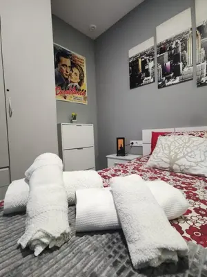 a bedroom with a bed with white pillows on it at Apartamento Suite CALETA in Cádiz