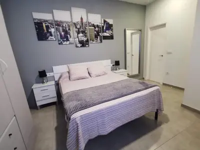 a bedroom with a bed with two pillows on it at Apartamento Suite CALETA in Cádiz