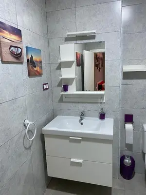 a bathroom with a white sink and a mirror at Apartamento Suite CALETA in Cádiz