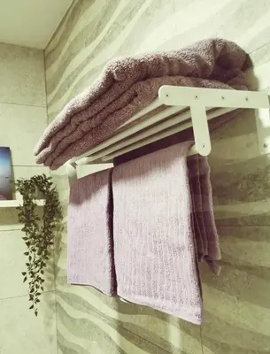 a towel rack with towels on it in a bathroom at Apartamento Suite CALETA in Cádiz