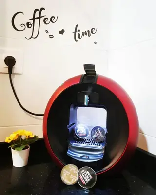 a bottle of water in a red bowl on a counter at Apartamento Suite CALETA in Cádiz