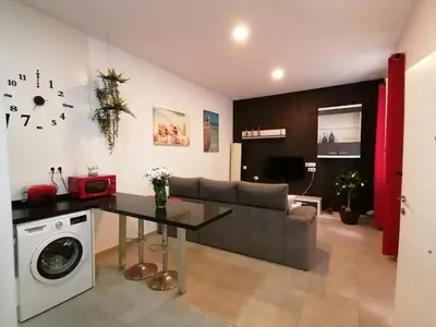 a living room with a couch and a table at Apartamento Suite CALETA in Cádiz