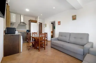 a living room with a couch and a table at Novobarrosa Apartamentos Turísticos in Chiclana de la Frontera