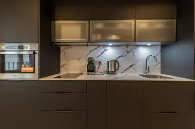 a kitchen with a sink and a stove at Allo Apartments San Roque 1ºA in Cádiz